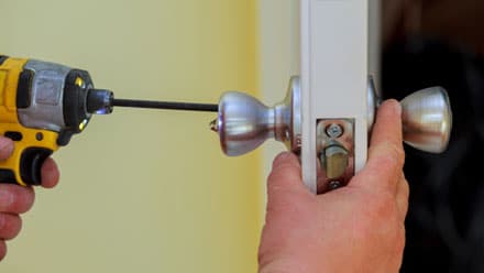 Contracting fixing a door knob.
